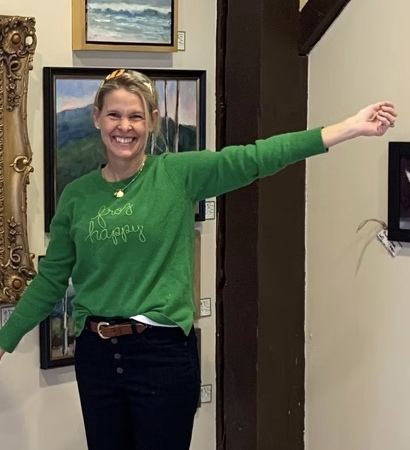 Jennifer Hooley in a gallery surrounded by her paintings