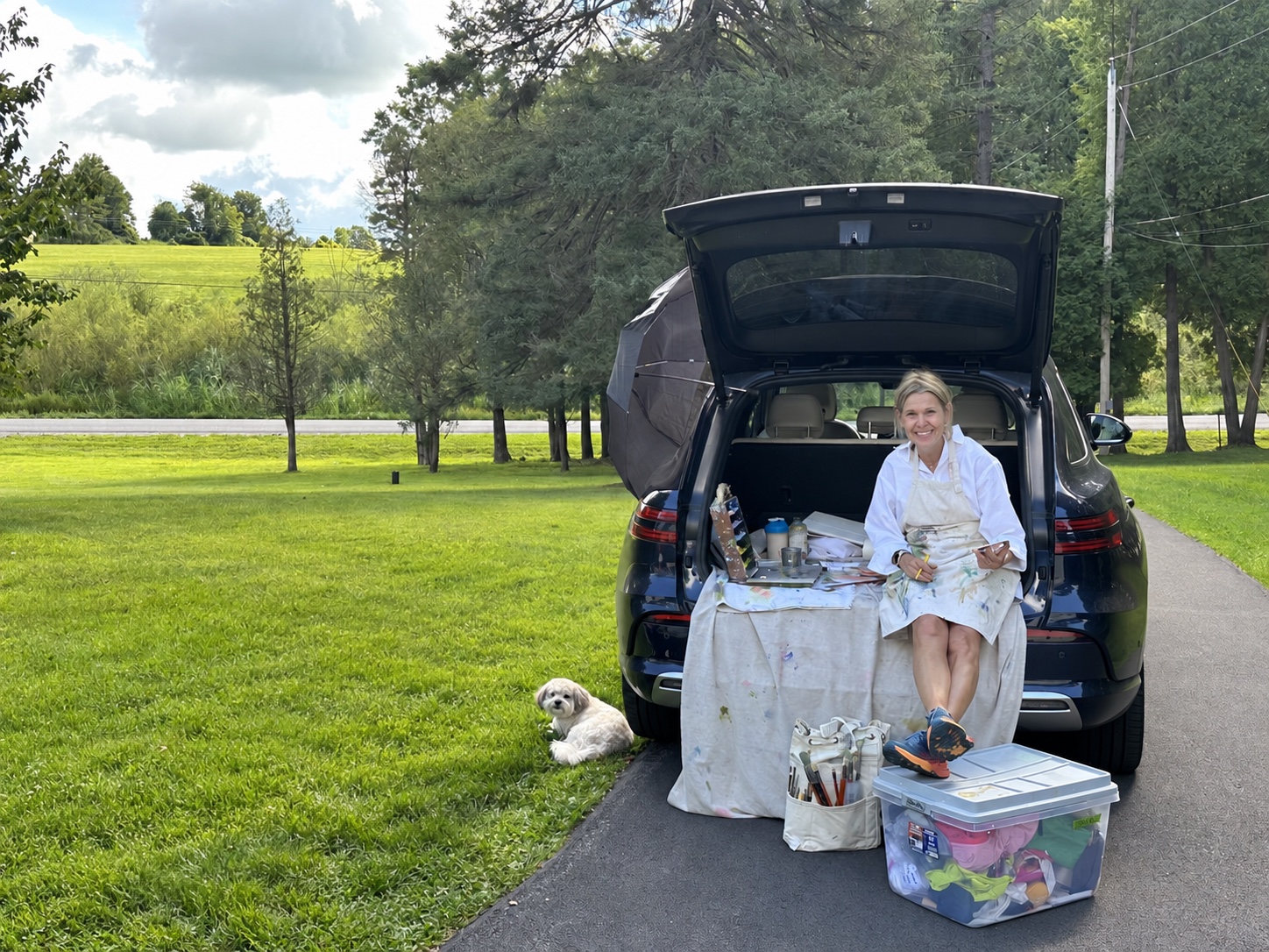 Jennifer Hooley painting outdoors beside her plein-air setup
