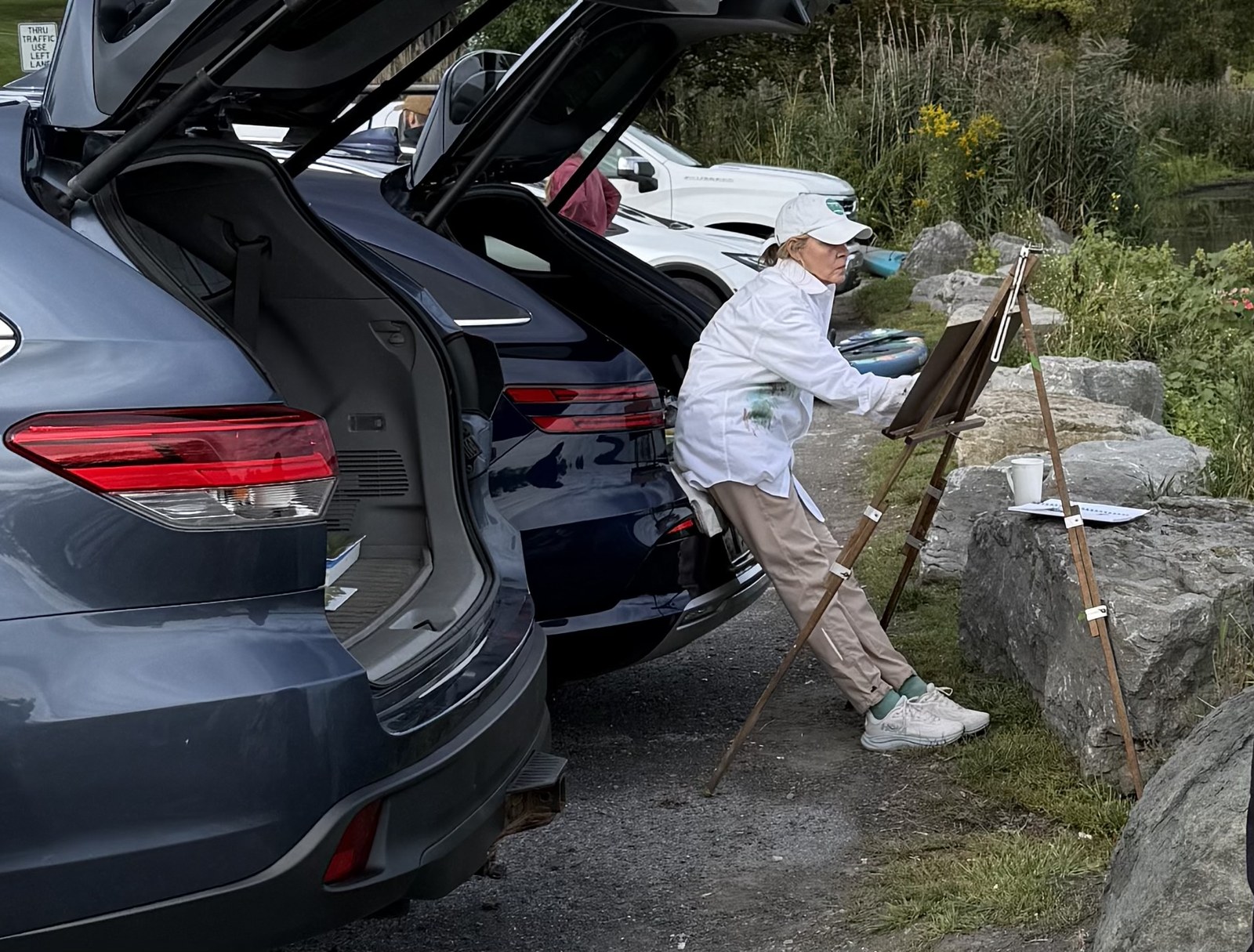 Painting beside the car with an outdoor easel