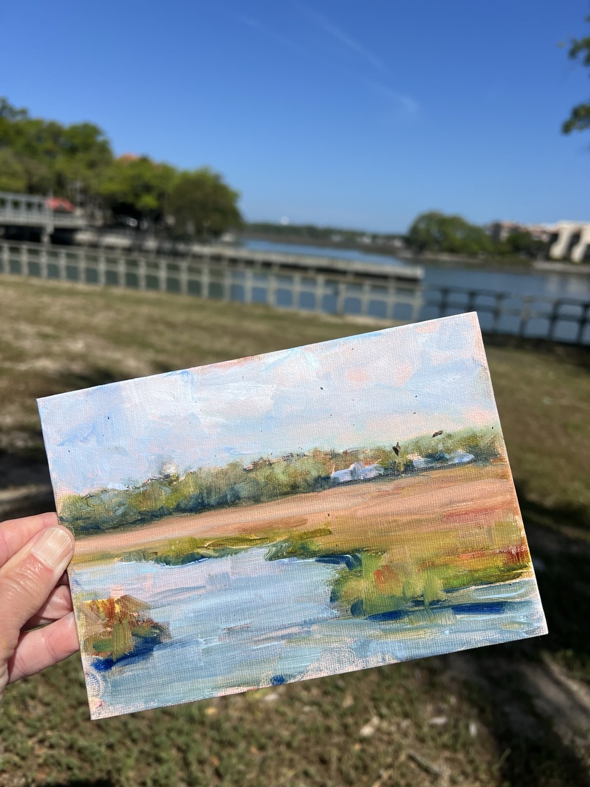 A small painting of water and the shoreline