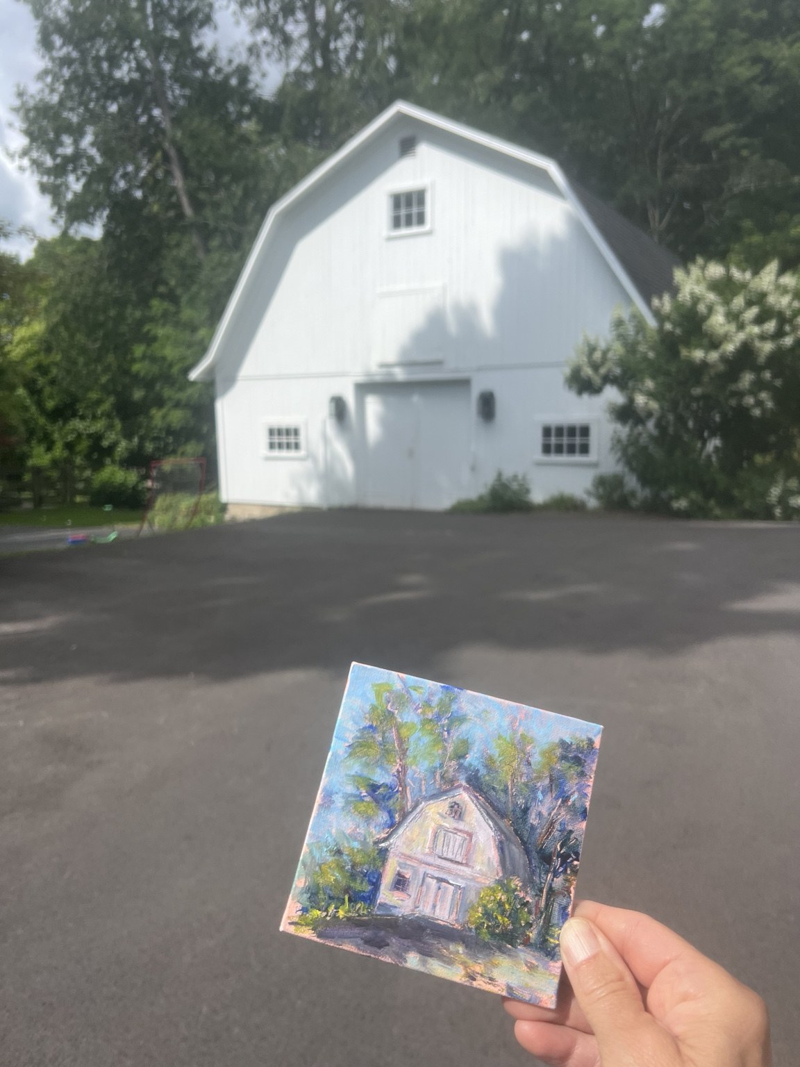 A painted study of a white barn beside the original view